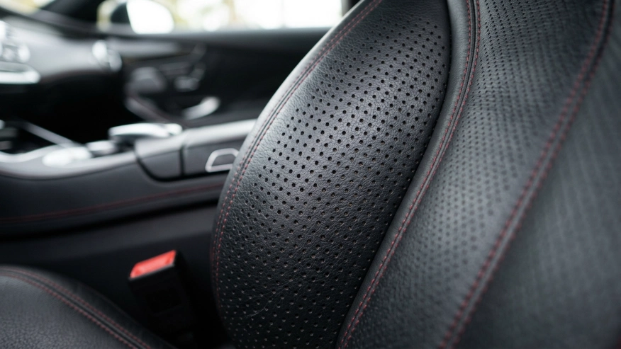 Close up view of perforated leather car seat showing texture.