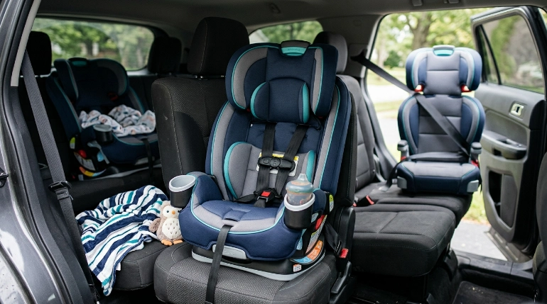 Three-mode Evenflo-style car seat showing rear-facing, harness and high-back booster use