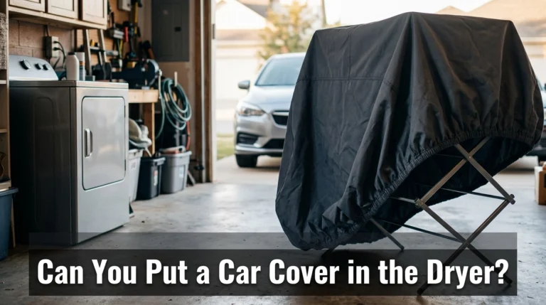 Car cover drying rack beside a clothes dryer in a garage.